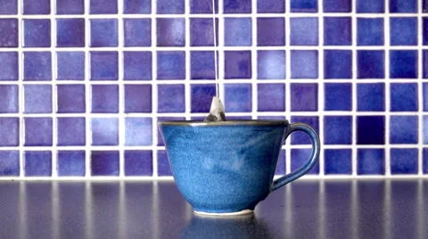 Tea cup and teabag on kitchen counter. Slow motion film clip. Stock Footage 67956185