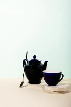 Tea cup and teapot on the table. Stock Photos