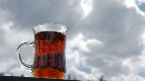 Tea Cup on a background of clouds. Timelaps. Stock Footage 83109080
