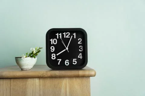 Tea cup ceramic with wild white green flower and black clock time in morning Stock Photos