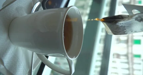Tea cup in coffee shop in front of window, vertical 4K Stock Footage 235356891