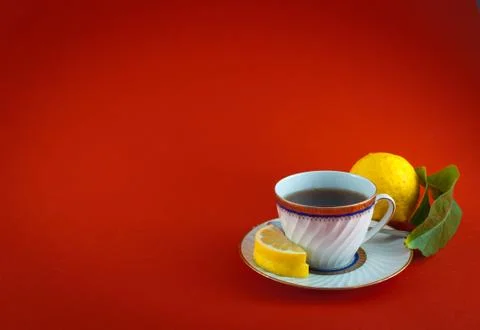 Tea cup lemon leaf colored closeup Stock Photos