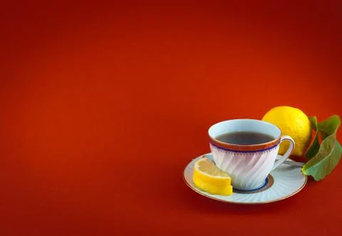 Tea cup lemon leaf colored closeup Stock Photos