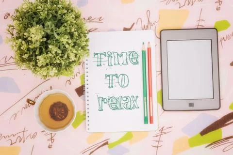 Tea cup, notebook and ebook Stock Photos