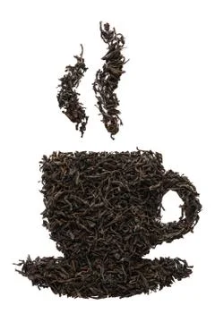 Tea cup shape made of dry black tea leaves. Stock Photos