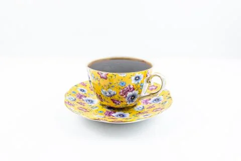 Tea cup with tea inside on the white table Stock Photos