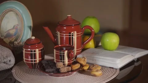 Tea, Cup, teapot, chocolate bar, cane sugar, cozy house Stock Footage 134887185