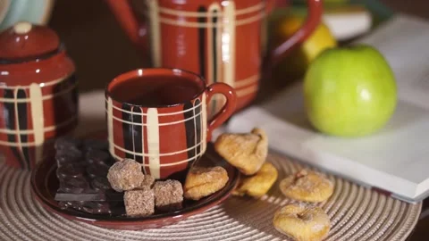 Tea, Cup, teapot, chocolate bar, cane sugar, cozy house Stock Footage 134887304