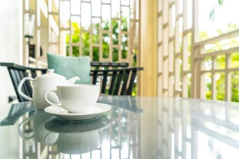 Tea cup with teapot on table Stock Photos