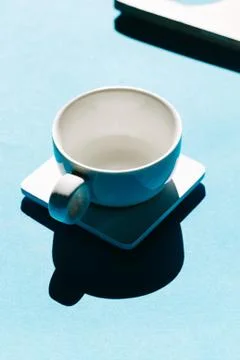 Tea cups set on blue background. Minimalist breakfast photo. Stock Photos