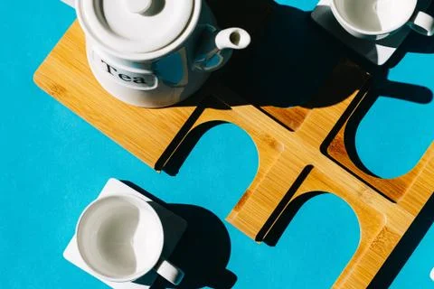 Tea cups set on blue background. Minimalist breakfast photo. Stock Photos