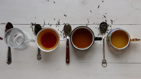 Tea cups set with tea at wooden background. Top view and flat lay video. Stock Footage 114311978