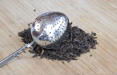 Tea Diffuser Spoon in Pile of Loose Tea Stock Photos