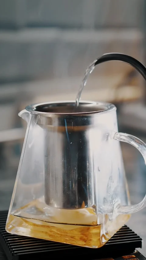 Tea drink. making tea. close-up. tea master pours boiling water into glass Stock Footage 323436728