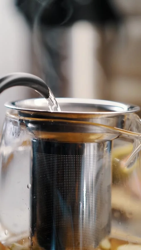Tea drink. making tea. close-up. boiling water is poured into glass teapot with Stock Footage 323436749