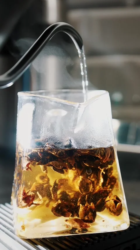 Tea drink. preparation of special fruit tea. close-up. tea master pours boiling Stock Footage 323512743