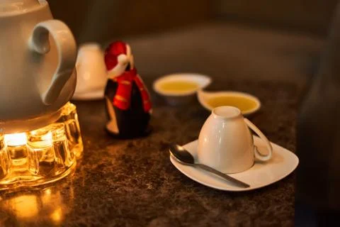 Tea drinking area, on the table there is a white tea kettle Stock Photos