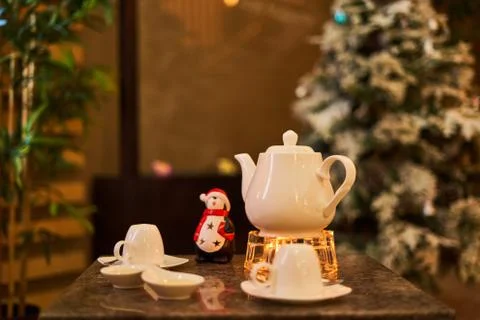 Tea drinking area, on the table is a white tea kettle Stock Photos