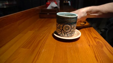 Tea drinking in cosy restaurant. waiter serves coffee or tea. Stock Footage 155393774