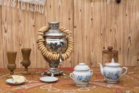 Tea drinking. Samovar, bagels, tea set and pancake on a saucer Stock Photos