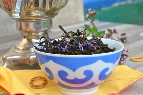 Tea drinking, samovar with herbal tea (blooming sally). Stock Photos