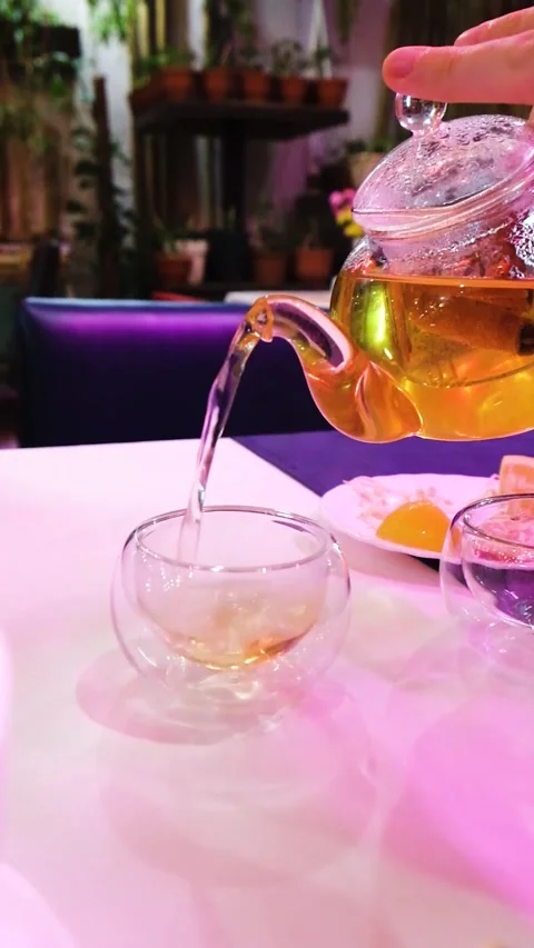 Tea Drop: Pouring Brew into Glass by Young Woman Video stock 343551502