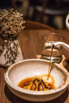 Tea Egg with Soubise , Mandarin pu-erh broth and Gingko Stock Photos