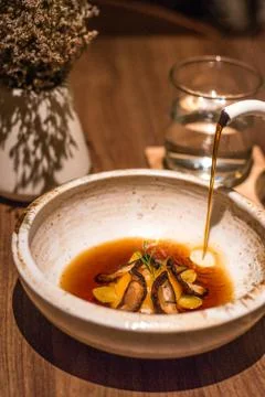 Tea Egg with Soubise , Mandarin pu-erh broth and Gingko Stock Photos