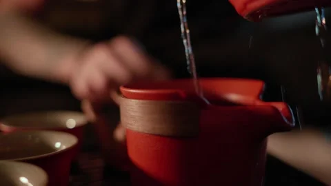 Tea Flowing into Traditional Teaware Stock Footage 321933344