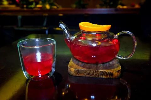 Tea from forest berries fruit with a slice of orange on a wooden stand with a Stock Photos