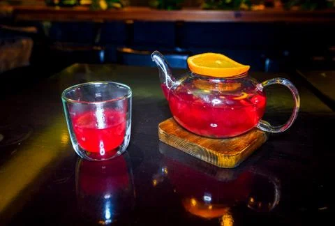 Tea from forest berries fruit with a slice of orange on a wooden stand with a Stock Photos