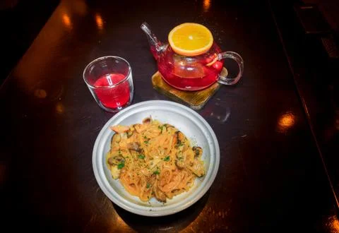 Tea from forest berries fruit with a slice of orange on a wooden stand with a Stock-Fotos