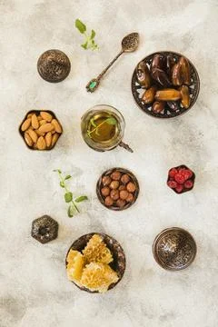 Tea glass with dates fruit nuts table Stock Photos