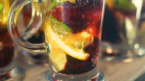 Tea in a glass, lemon, mint, orange, drops, spray, slow-motion shooting. Stock Footage 102111553