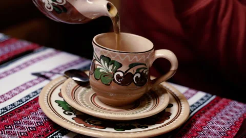 Tea. A hand pours tea into a cup from a teapot. Stock Footage 154332094