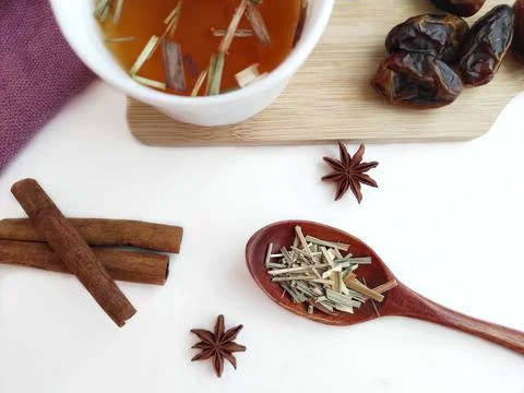 Tea with herbs and dates with the addition of cinnamon and star anise Stock Photos