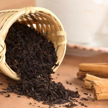 Tea infuser with black tea Stock Photos
