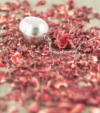 Tea infuser over red tea Stock Photos