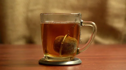 Tea Infusing into Mug on Coaster Stock Footage 35728192