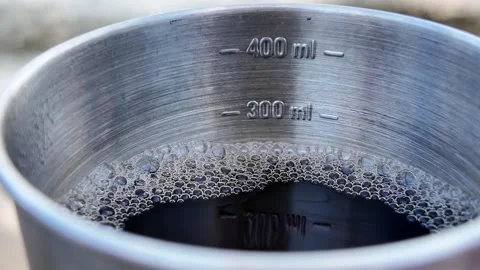 Tea in an iron measuring mug. Stock Footage 317628977