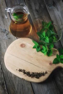 Tea in a jar and mint on the table Stock Photos