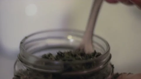 Tea in a jar scooped with spoon Stock Footage 135584585