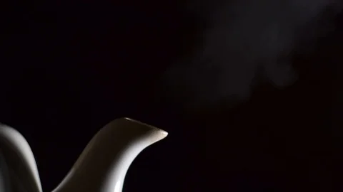 Tea kettle with boiling water on black background Stock Footage 100559555