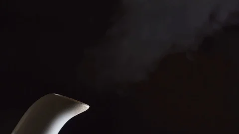 Tea kettle with boiling water on black background Stock Footage 100559598