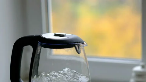 Tea kettle with boiling water in the kitchen close up, preparing hot drink Stock Footage 97209140