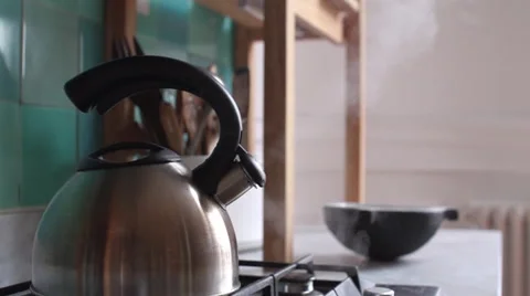 Tea kettle emitting steam Stock Footage 63303396