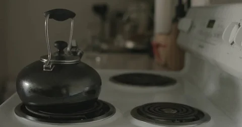 Tea kettle on stove in kitchen Stock Footage 78038173
