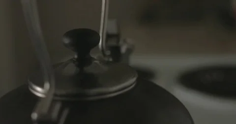Tea kettle on stove in kitchen Stock Footage 78038243