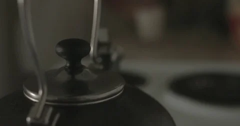 Tea kettle on stove in kitchen Stock Footage 78038264