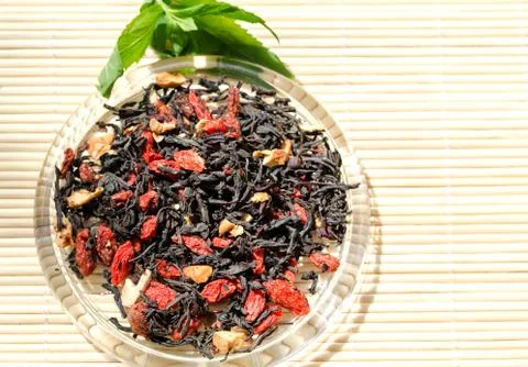 Tea leaf with Goji berries Stock Photos